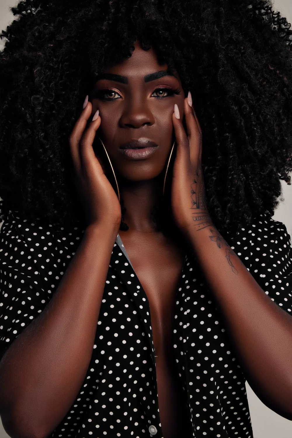 Woman with voluminous black curls; representative hairstyle image. Representative image, not a photograph of Indian Deep Curly Bundle.